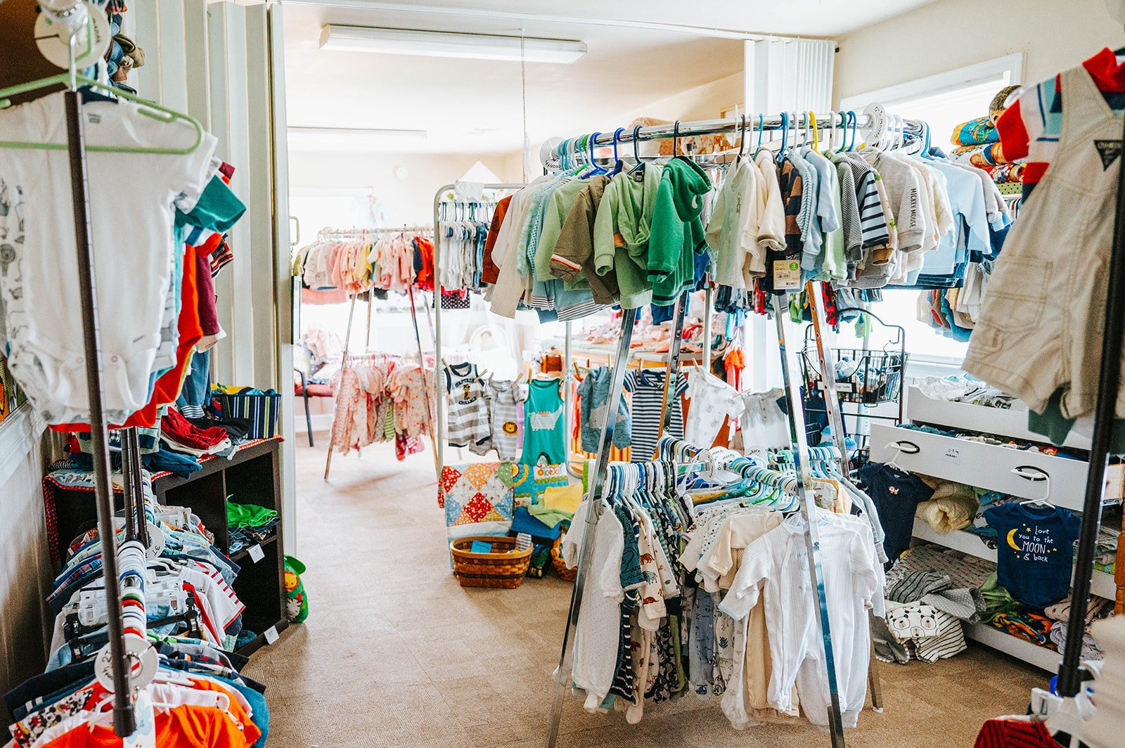 Racks of baby clothing in the Safe Choice Baby Boutique