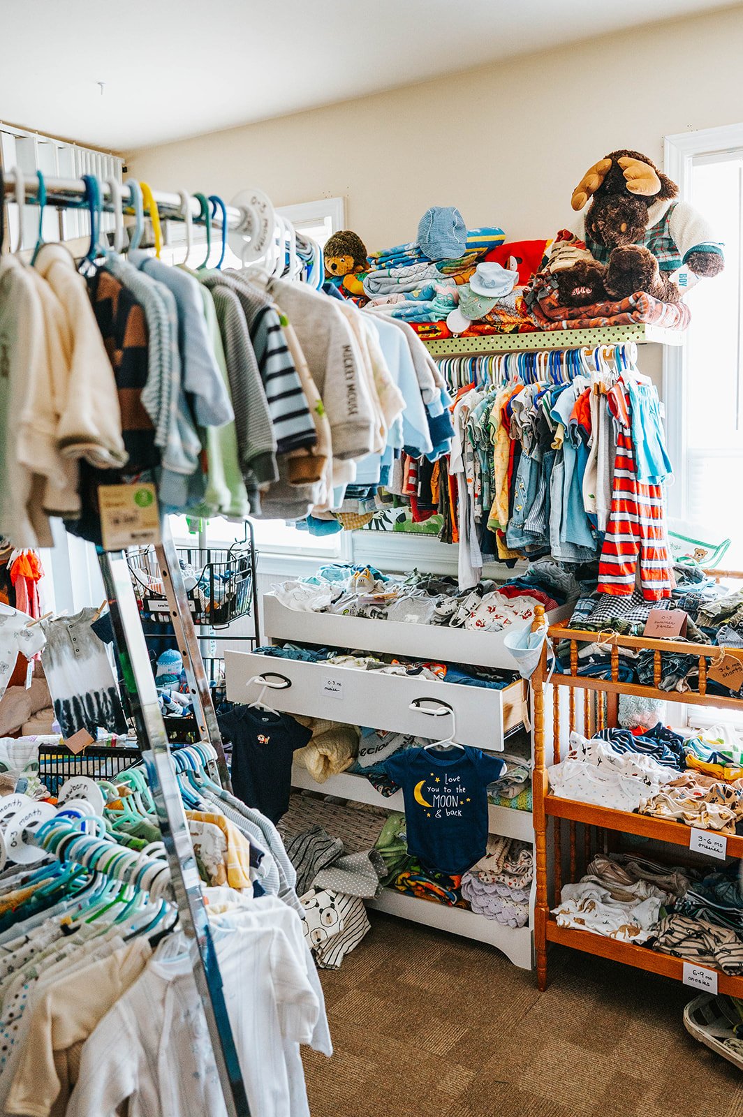 Racks of baby clothing in the Safe Choice Baby Boutique