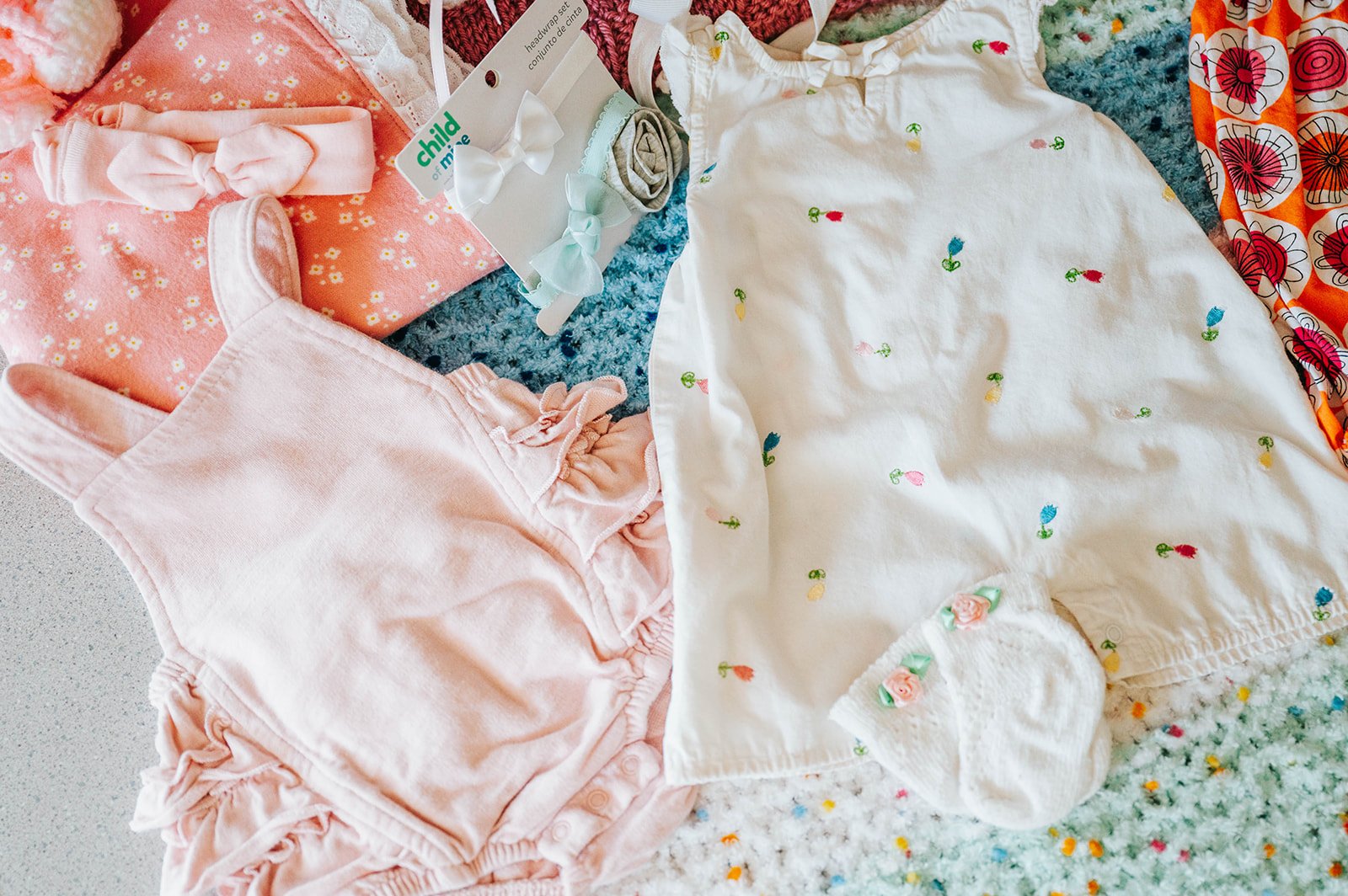 Baby outfits laid out with care