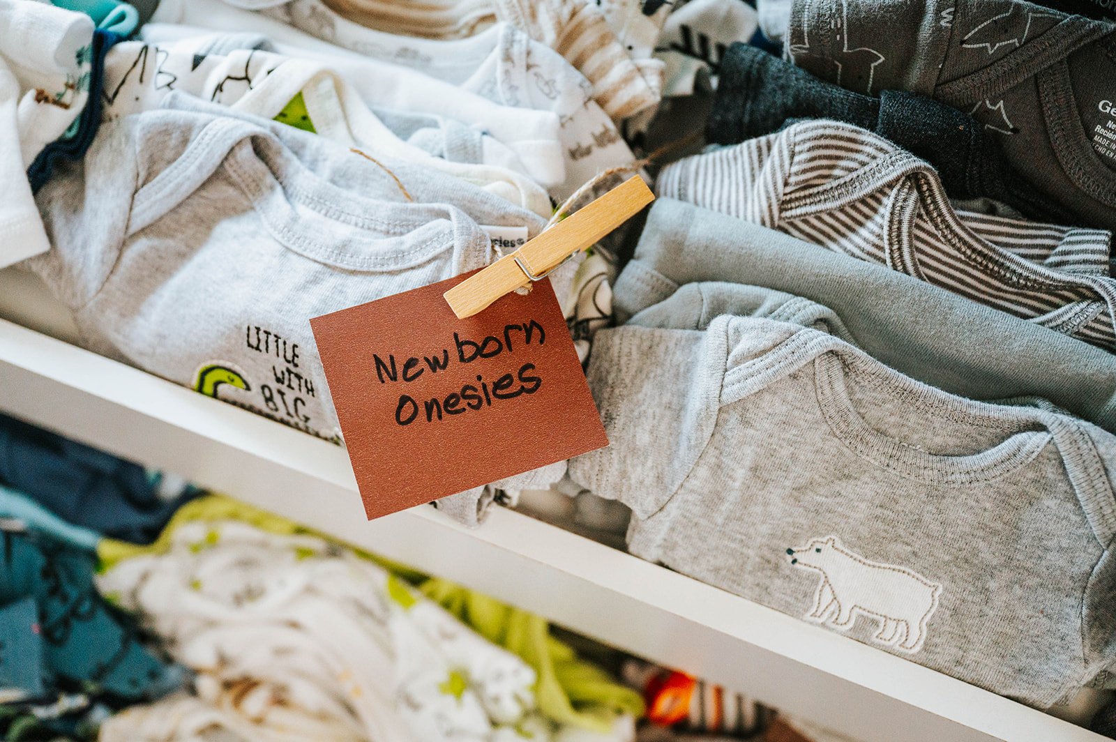 Labeled drawers of newborn onesies in the Baby Boutique