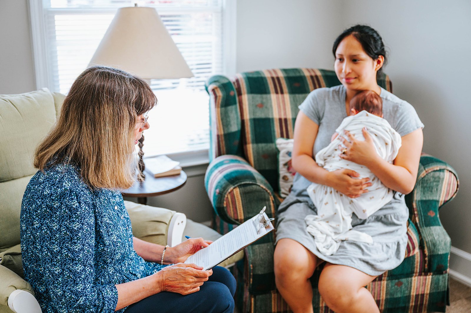 A Safe Choice counselor visiting with a mother and her newborn