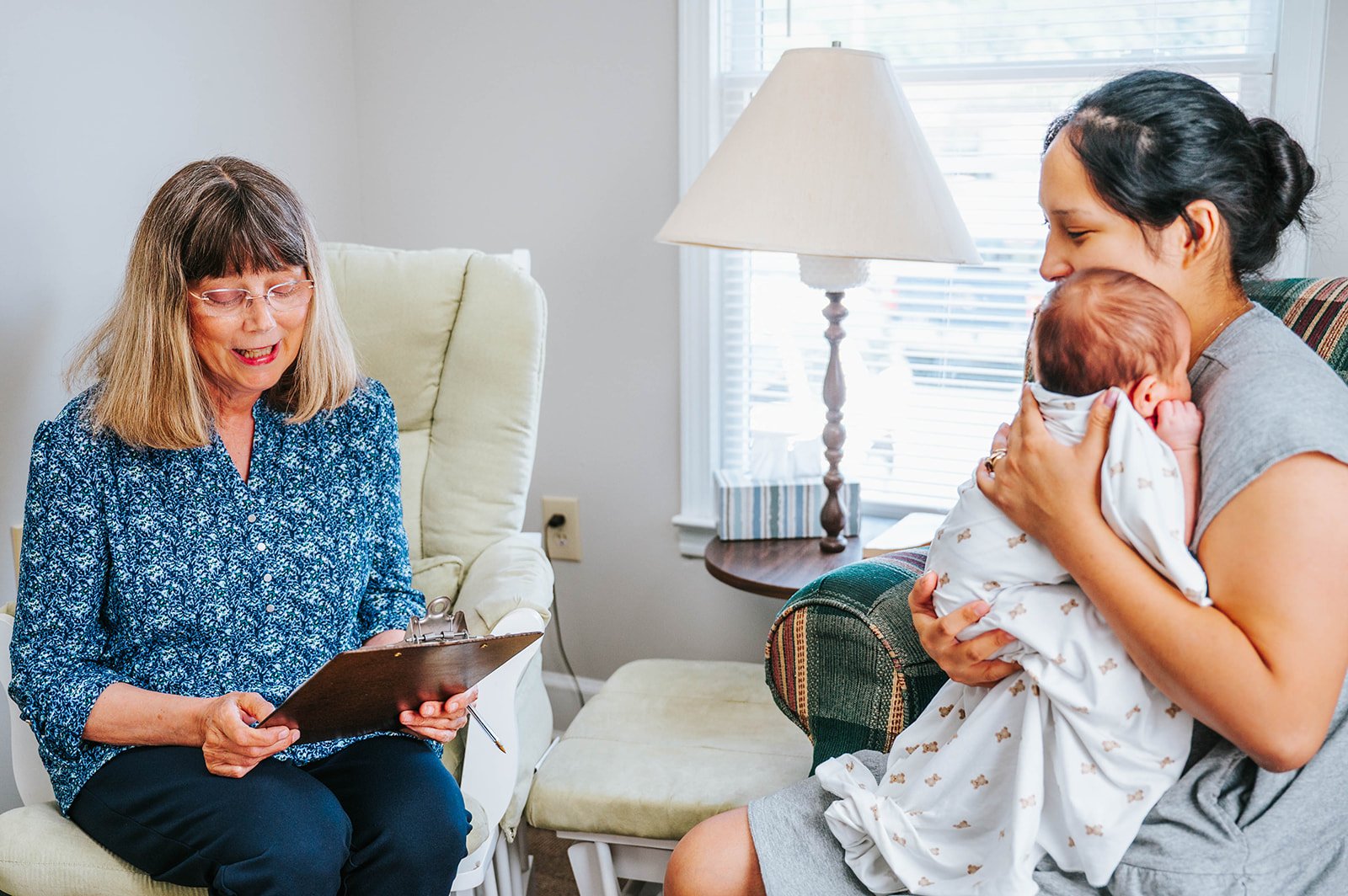A Safe Choice counselor sitting with a mother and her newborn
