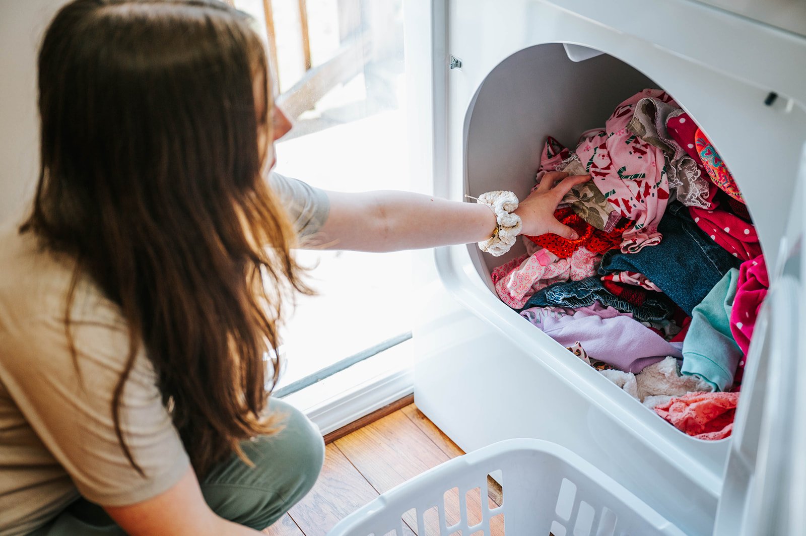A volunteer sorting donated baby clothes